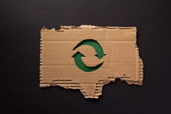 Recycle symbol at  recycled paper background texture. Recycling idea concept and cardboard paper